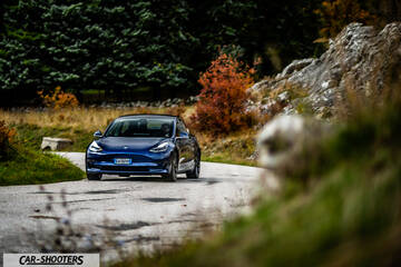 Tesla Model S Performance – front three-quarter, blue on a winding country road