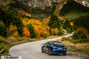 Tesla Model S Performance – rear three-quarter, blue metallic on a mountain road