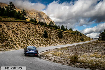 Tesla Model S Performance – rear view, dark blue on a mountain road