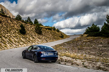 Tesla Model S Performance – rear three-quarter, dark blue on a winding mountain road