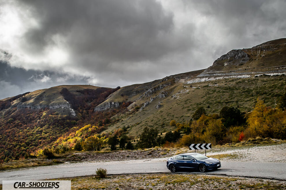 Tesla Model S Performance – front three-quarter, dark blue against a mountain backdrop