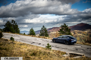 Tesla Model S Performance – rear three-quarter, dark blue on a mountain road