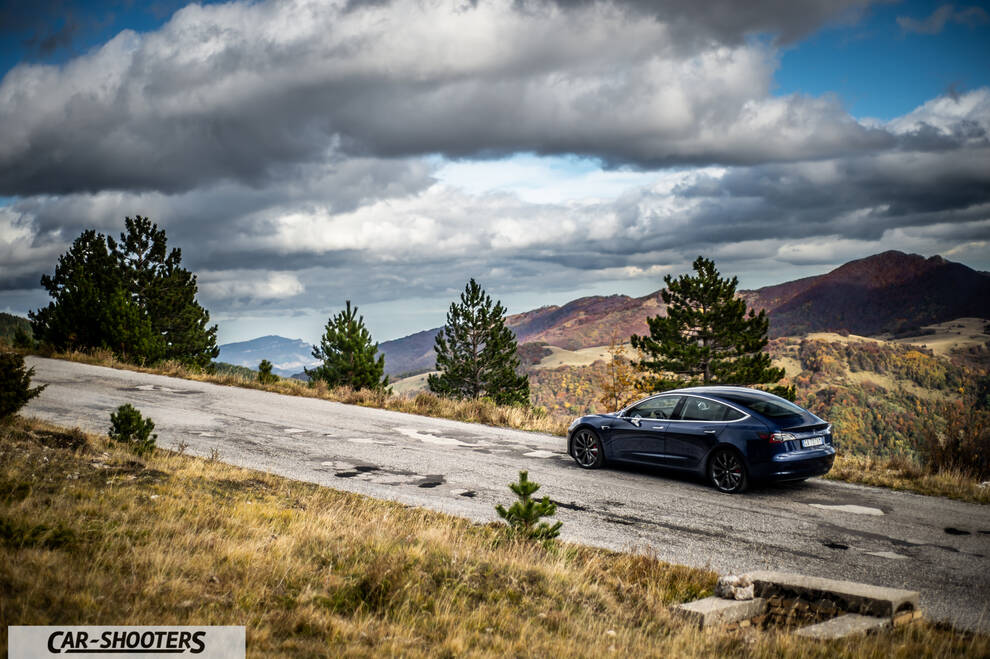 Tesla Model S Performance – rear three-quarter, dark blue on a mountain road