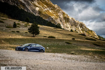 Tesla Model S Performance – side profile, blue against a mountain backdrop