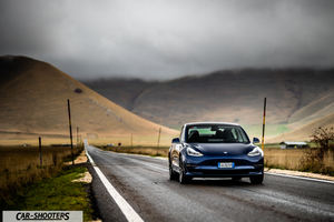 Tesla Model S Performance – front three-quarter, dark blue on a country road