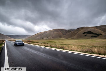 Tesla Model S Performance – front three-quarter, dark blue on a country road