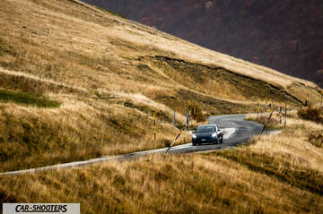 Tesla Model S Performance – front three-quarter, dark grey on a winding mountain road