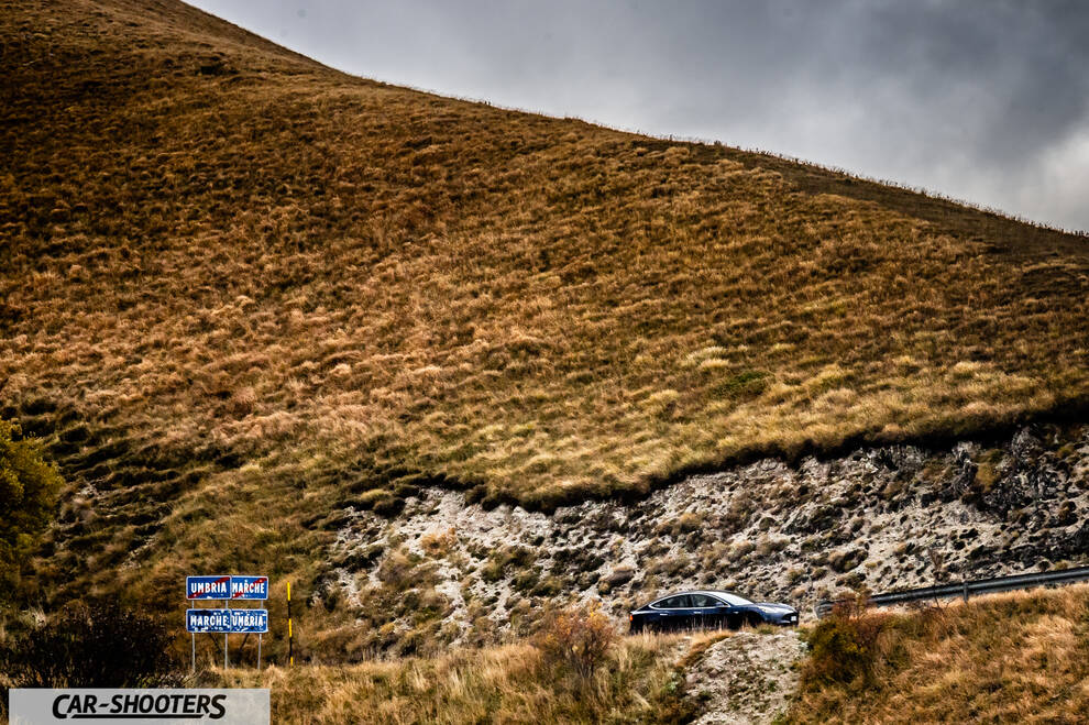 Tesla Model S Performance – side profile, dark blue against a mountain backdrop