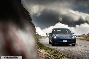 Tesla Model S Performance – front three-quarter, dark blue against a mountain backdrop