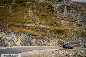 Tesla Model S Performance – rear three-quarter, blue against a mountain backdrop