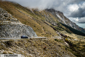 Tesla Model S Performance – side profile, dark blue against a mountain backdrop