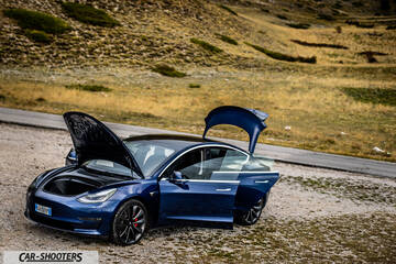Tesla Model S Performance – front three-quarter, blue on a mountain road