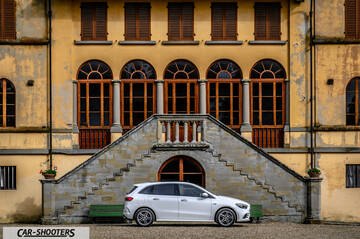 Mercedes Benz Classe B – side profile, white in front of a grand building