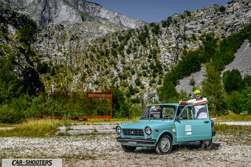 Autobianchi A112 – front three-quarter, light blue against a mountain backdrop