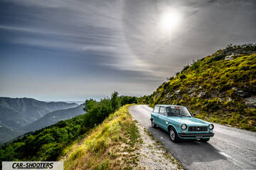 Autobianchi A112 – front three-quarter, light blue on a mountain road