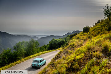 Autobianchi A112 – rear three-quarter, light blue on a mountain road