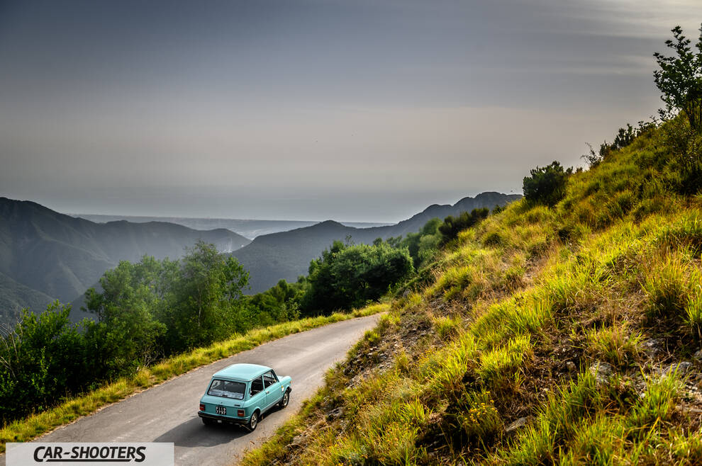 Autobianchi A112 – rear three-quarter, light blue on a mountain road