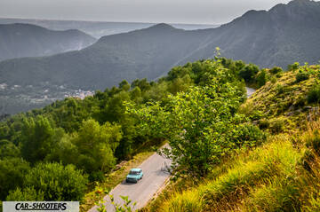 Autobianchi A112 – side profile, light blue light blue on a mountain road