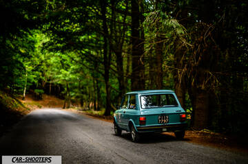 Autobianchi A112 – rear three-quarter, light blue on a forest road