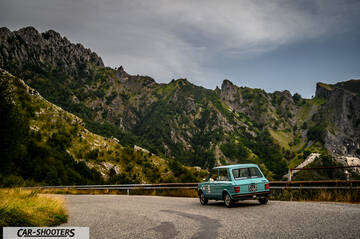 Autobianchi A112 – rear three-quarter, light blue against a mountain backdrop