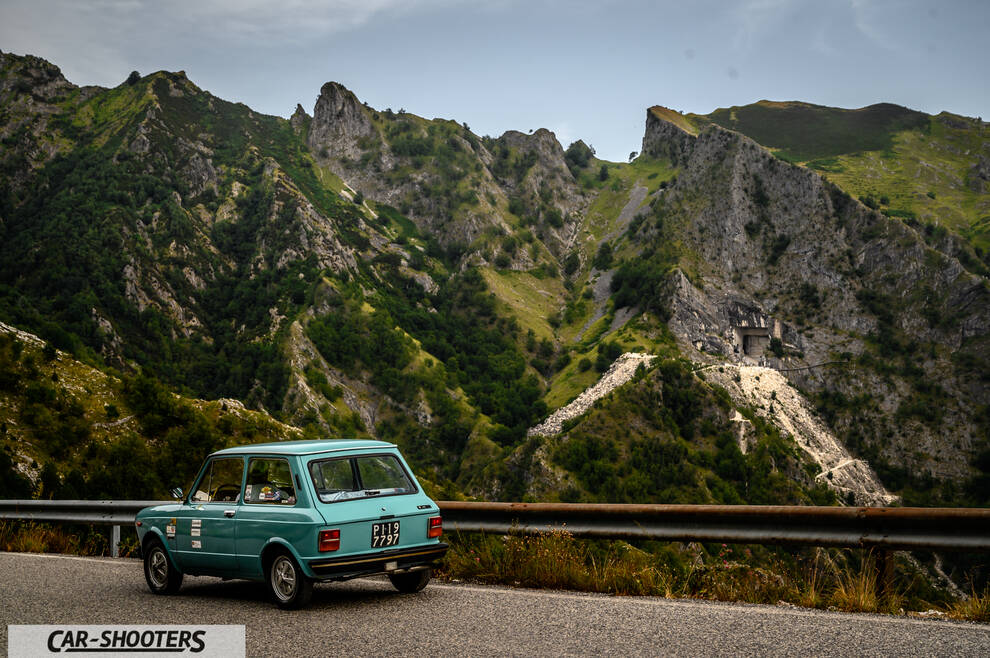 Autobianchi A112 – rear three-quarter, light blue against a mountain backdrop