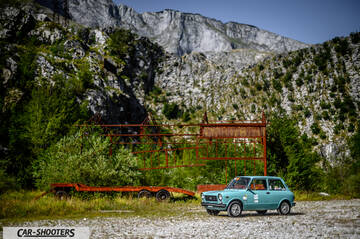 Autobianchi A112 – front three-quarter, light blue against a mountain backdrop