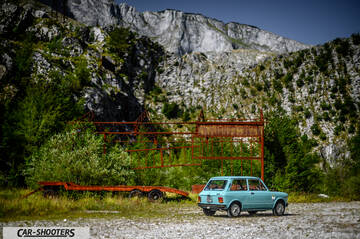 Autobianchi A112 – rear three-quarter, light blue against a mountain backdrop