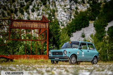 Autobianchi A112 – front three-quarter, light blue against a mountain backdrop