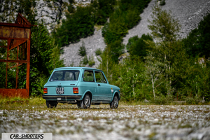 Autobianchi A112 – rear three-quarter, light blue against a mountain backdrop