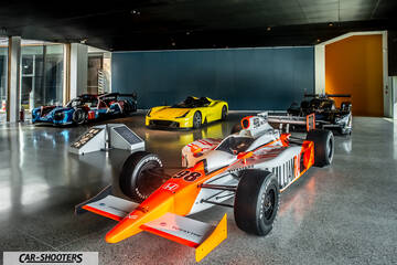 Dallara – front three-quarter, white and orange in a modern indoor showroom