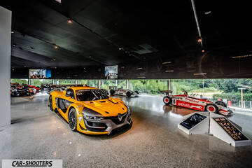 Dallara – front three-quarter, yellow inside a modern showroom