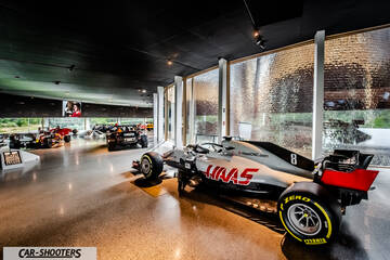 Dallara – rear three-quarter, white in a museum exhibit hall