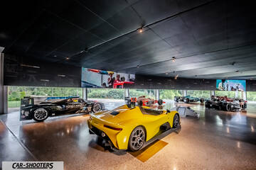 Dallara – rear three-quarter, yellow in a museum gallery