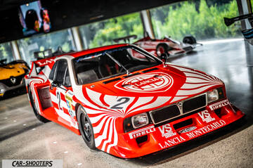 Dallara – front three-quarter, red and white in a showroom