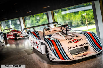 Dallara – front three-quarter, white with racing livery in a showroom