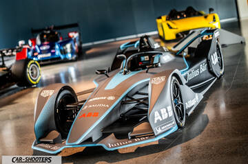 Dallara – front three-quarter, grey and blue in an indoor showroom