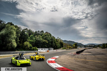 Dallara Stradale – front three-quarter, yellow on a racetrack with dramatic sky