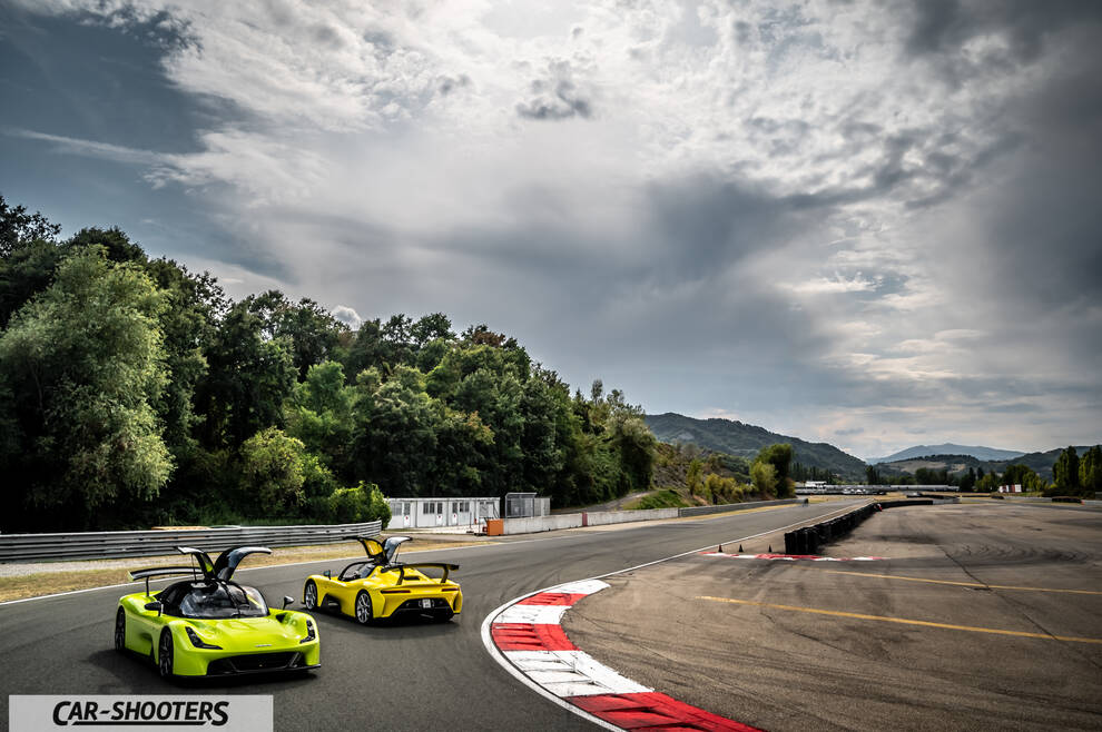 Dallara Stradale – front three-quarter, yellow on a racetrack with dramatic sky
