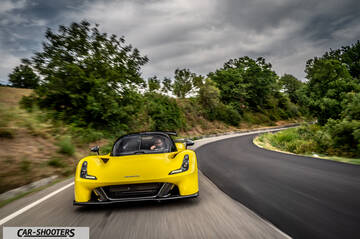 Dallara Stradale – front three-quarter, yellow on a winding country road