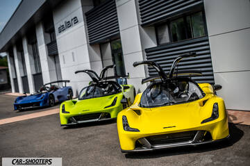 Dallara – front three-quarter, yellow in front of a building