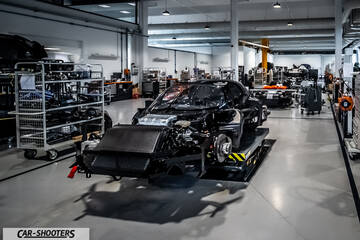 Dallara – front three-quarter, black in a factory workshop