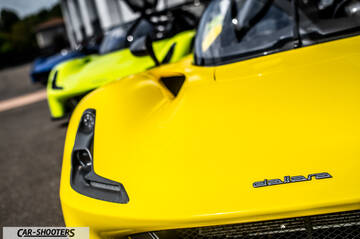 Dallara – front three-quarter, yellow parked alongside other exotic cars