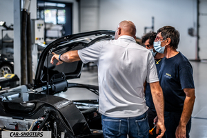 Dallara – detail, mechanics inspecting a car in a workshop