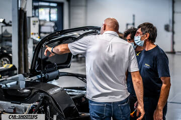 Dallara – detail, mechanics inspecting a car in a workshop