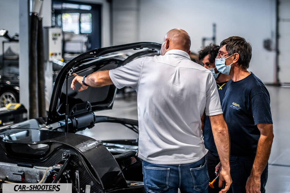Dallara – detail, mechanics inspecting a car in a workshop