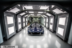 Dallara – front three-quarter, dark blue in a lit tunnel setting