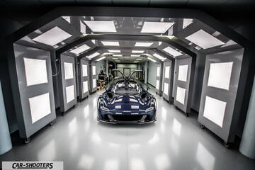 Dallara – front three-quarter, dark blue in a lit tunnel setting