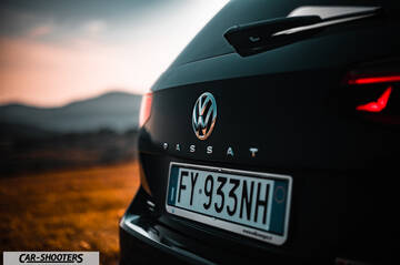 Volkswagen Passat Alltrack – rear view, black against a sunset mountain backdrop