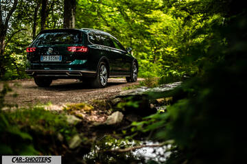 Volkswagen Passat Alltrack – rear three-quarter, dark green on a country road