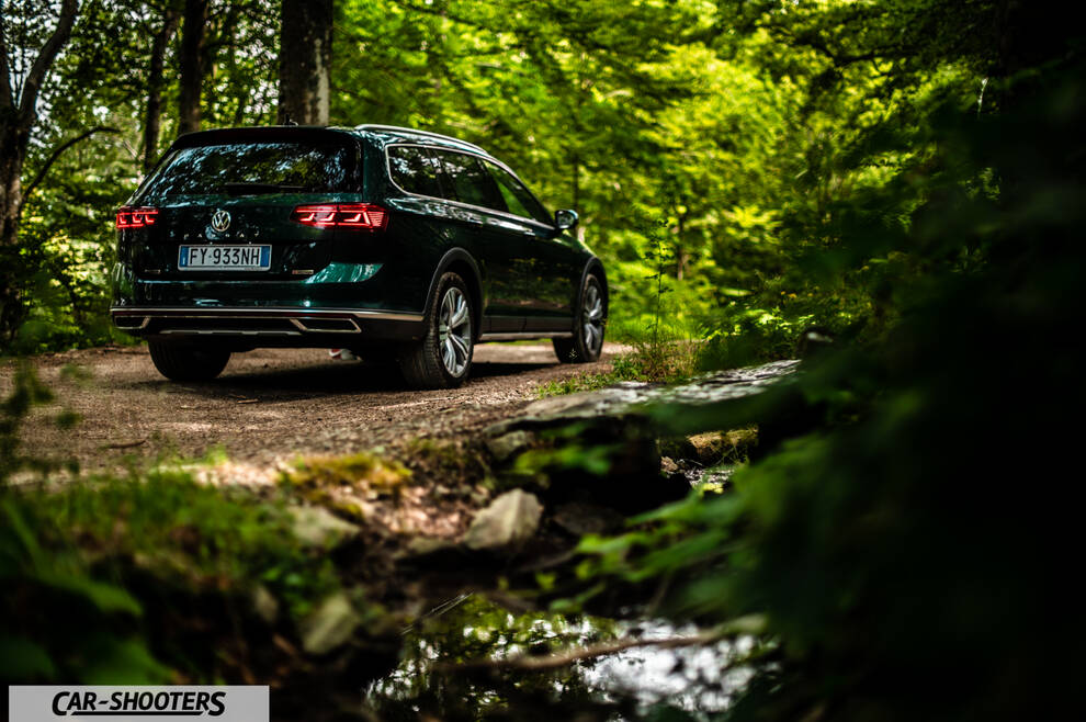 Volkswagen Passat Alltrack – rear three-quarter, dark green on a country road